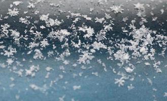 flocons de neige sur fond bleu. gros plan de la texture de la neige, informations naturelles de Noël photo