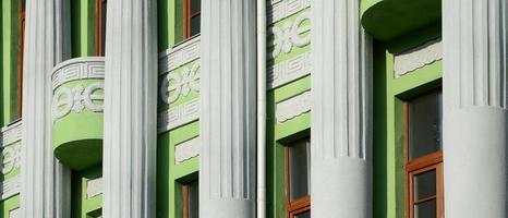 ancien bâtiment à plusieurs étages restauré avec des colonnes antiques, peint en vert photo