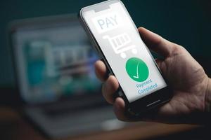 main d'homme utilisant le paiement électronique sur téléphone mobile, client tenant un smartphone et effectuant une transaction de paiement numérique. photo