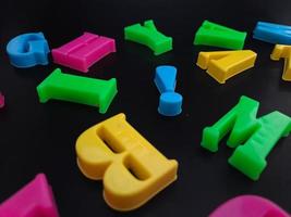 gros plan d'alphabets colorés sur fond noir parfait pour l'éducation des enfants photo