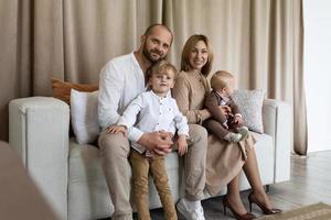 portrait d'une jeune famille élégante avec deux enfants mâles photo