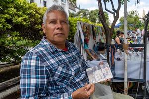 artiste de rue âgé, homme latino brun, peignant des images dans la rue, mexique photo