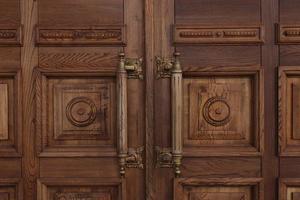 portes en bois massives antiques avec de grandes poignées en gros plan. architecture ancienne. photo