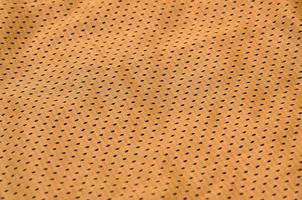 texture de vêtements de sport en fibre de polyester. les vêtements d'extérieur pour l'entraînement sportif ont une texture en maille de tissu en nylon extensible photo