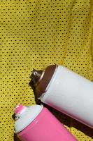 plusieurs pulvérisateurs de peinture en aérosol usagés se trouvent sur la chemise de sport d'un joueur de basket-ball en tissu polyester. le concept d'art de rue pour les jeunes, de sports actifs et de style de vie mouvementé photo