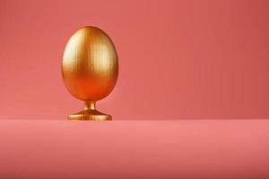 oeuf d'or sur fond rose avec un concept minimaliste. espace pour le texte. modèles de conception d'oeufs de pâques. décor élégant avec un concept minimal. photo