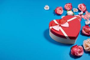 une carte postale d'une boîte en forme de coeur et de boutons de rose.concept de la saint-valentin photo