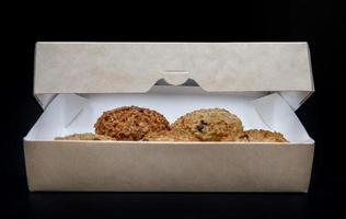 les biscuits à l'avoine faits maison sont dans une boîte en carton entrouverte. photo