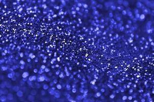 paillettes décoratives bleues. image de fond avec des lumières bokeh brillantes à partir de petits éléments photo