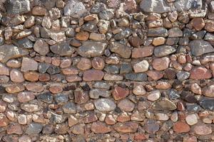 fond de mur de pierre médiévale aux beaux jours. texture photo