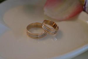 anneaux de mariage sur une soucoupe blanche photo