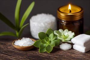 articles de soins de beauté pour les procédures de spa sur table en bois blanc avec plante verte. pierres de massage, huiles essentielles et sel de mer avec bougie allumée. photo