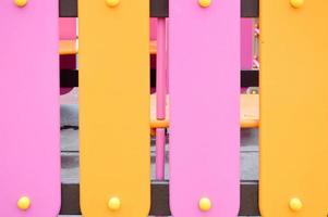 planches de clôture verticales en bois jaunes et roses. arrière-plan, texture photo