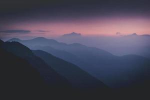silhouettes de montagnes au coucher du soleil photo