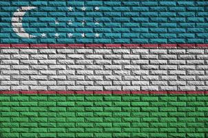 le drapeau de l'ouzbékistan est peint sur un vieux mur de briques photo