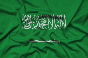 le drapeau de l'arabie saoudite est représenté sur un tissu de sport avec de nombreux plis. bannière de l'équipe sportive photo