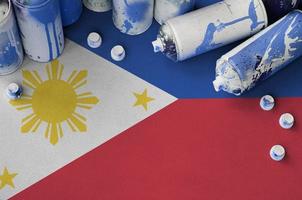 drapeau des philippines et quelques bombes aérosols utilisées pour la peinture de graffitis. concept de culture d'art de rue photo