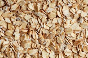 muesli aux céréales dorées, fond et texture. grains d'avoine. vue de dessus de petit-déjeuner sain. fermer photo