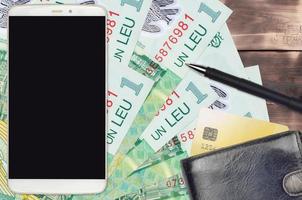 1 billets de leu roumain et smartphone avec sac à main et carte de crédit. paiements électroniques ou concept de commerce électronique. achats en ligne et affaires avec des appareils portables photo
