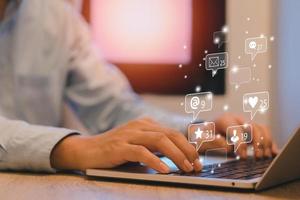 homme d'affaires tapant le clavier avec un ordinateur portable sur le bureau. médias sociaux et concept d'écran d'icônes virtuelles marketing. photo