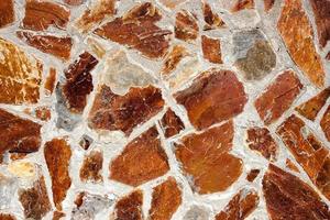 mur de pierres brunes en désordre. image horizontale. photo