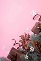 branches de pins avec vue de dessus de décoration de nouvel an cristmas, mise à plat sur fond rose avec espace de copie. carte de voeux vierge photo