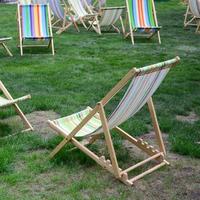 chaises longues sur une pelouse. transats de jardin sur l'herbe verte photo