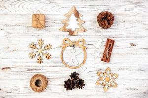 compositions de noël. cadeau, décoration de noël, flocon de neige, pommes de pin sur fond en bois vintage rustique. vue de dessus à plat photo