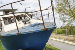 bateau naufragé abandonné allongé sur le rivage, en attente de réparations, bateau de pêche photo