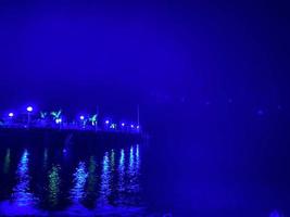 debout sur la plage en regardant le quai la nuit en turquie photo