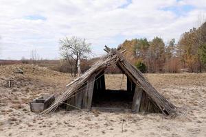 vestiges d'anciennes maisons faites de rondins creux avec des toits en bois et de chaume sur le pré photo