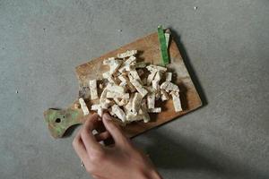 nourriture indonésienne tempeh cru coupé en carrés sur un fond de béton photo