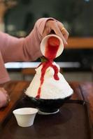 dessert coréen à la glace pilée avec garnitures sucrées, bingsu aux fraises sur table en bois photo