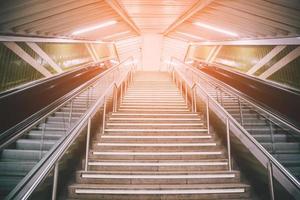 escalator vide et escalier dans la station de métro piétonne. escaliers du métro souterrain vers le haut. notion de voyage. L'Europe .