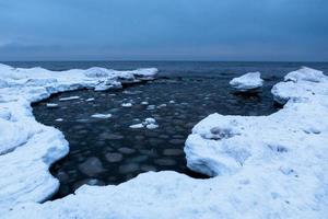 côte de la mer baltique en hiver avec de la glace au coucher du soleil photo