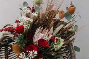 décoration rustique de seau à main de fleur de rose rouge pour une occasion spéciale comme un mariage, des fiançailles, un anniversaire et un dîner romantique. photo