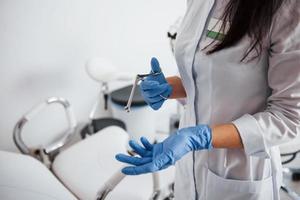 vue rapprochée des mains d'une femme médecin qui tient l'instrument rétracteur photo