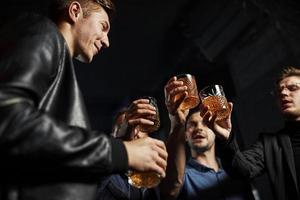 passer du temps le week-end. les gens s'amusent dans le club. avec de l'alcool dans les mains photo