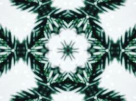 feuilles vertes floues fond kaléidoscope fleur abstraite et motif symétrique pour les vibrations de noël photo