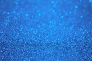 fond de paillettes bleu clair. texture de particules de paillettes bleu clair. photo