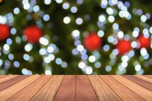 dessus de table en bois vide avec arbre de noël flou avec fond clair bokeh photo