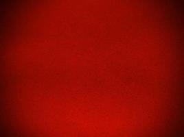 texture de tissu de velours rouge utilisée comme arrière-plan. fond de tissu rouge vide de matière textile douce et lisse. il y a de l'espace pour le texte. photo