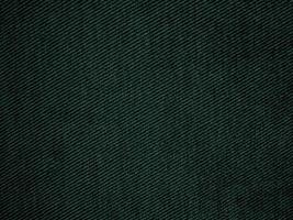 fond de texture en velours côtelé vert. texture de tissu en velours côtelé utilisée comme arrière-plan. fond de tissu vert vide de matière textile douce et lisse. il y a de l'espace pour le texte. photo