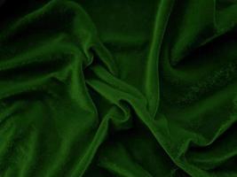 texture de tissu de velours vert et rouge utilisée comme arrière-plan. fond de tissu vert foncé et rouge vide de matière textile douce et lisse. il y a de la place pour le concept text.christmas. photo