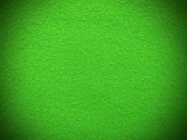 feutre vert doux matériau textile rugueux texture d'arrière-plan gros plan, table de poker, balle de tennis, nappe. fond de tissu vert vide. photo