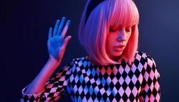 portrait de jeune fille aux cheveux blonds en néon rouge et bleu en studio photo