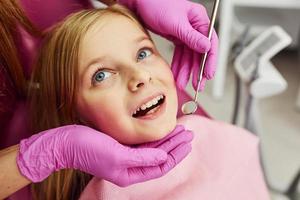 petite fille visitant un dentiste en clinique. conception de la stomatologie photo