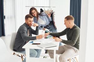 un groupe de personnes travaille au bureau en s'asseyant près de la table photo