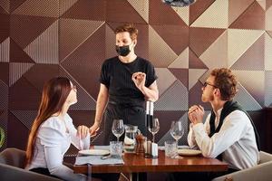 jeune petit ami avec une femme adulte. à l'intérieur du nouveau restaurant de luxe moderne photo