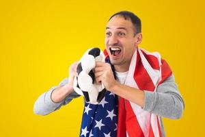 fan de football masculin avec une balle froissée et avec le drapeau américain photo